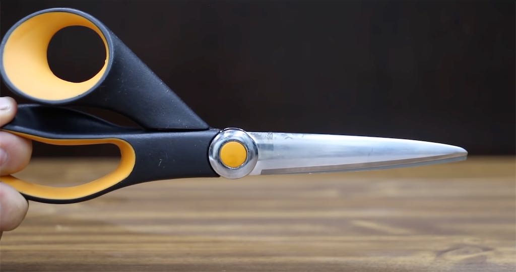 Fiskars brand scissors held in a hand