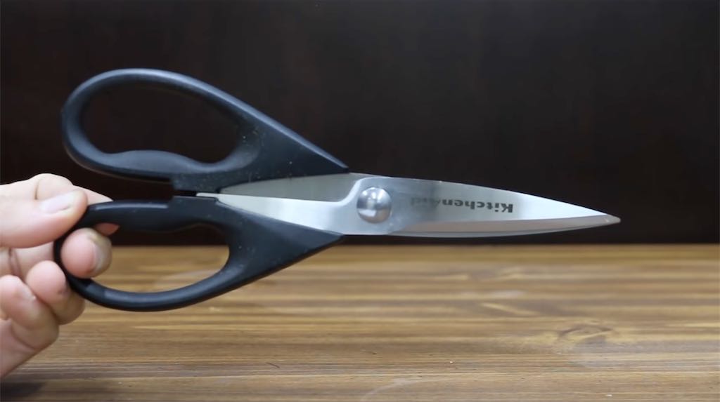 KitchenAid brand scissors held in a hand